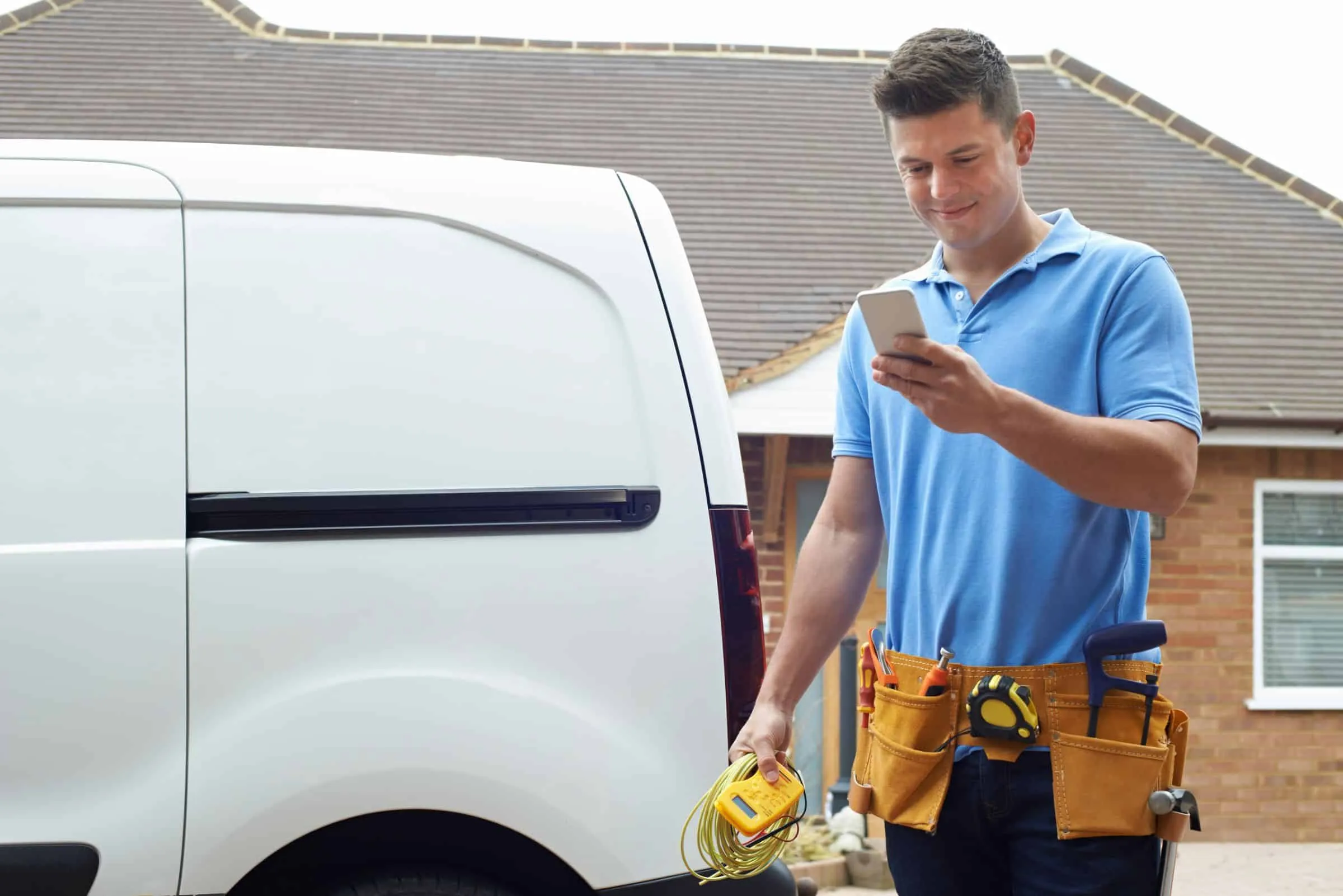 CNE electrician taking a customer call on site